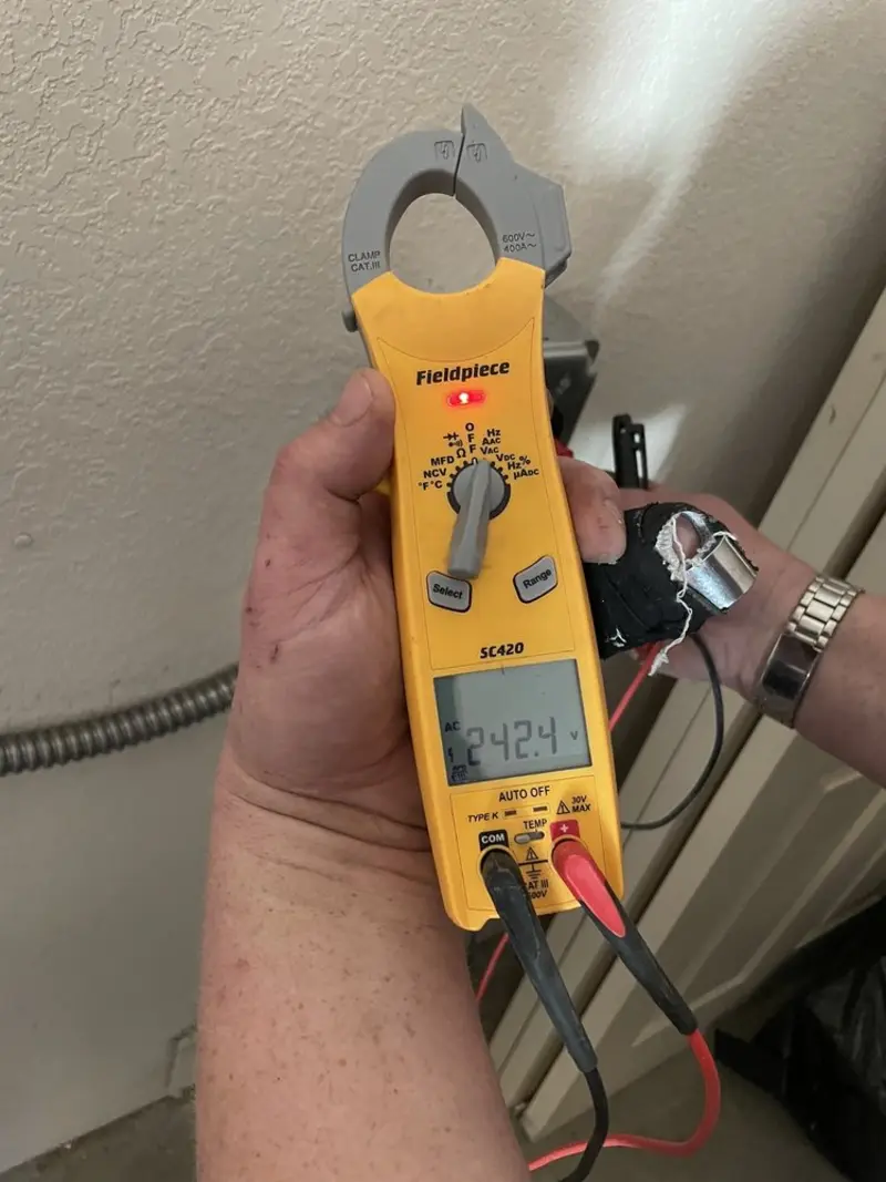 Voltage testing with clamp meter during Outlet Installation in Chatfield